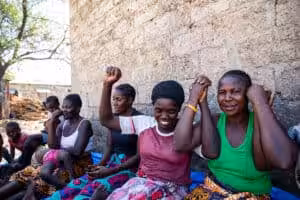 Women sitting together outdoors, encouraging each other during group talk therapy.
