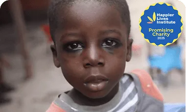 Child with a somber expression in a developing region.