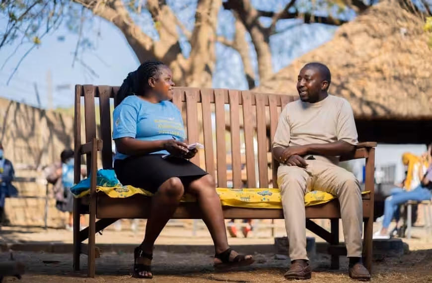 A man during a talk therapy session with a peer counsellor on a Friendship Bench in Zimbabwe.