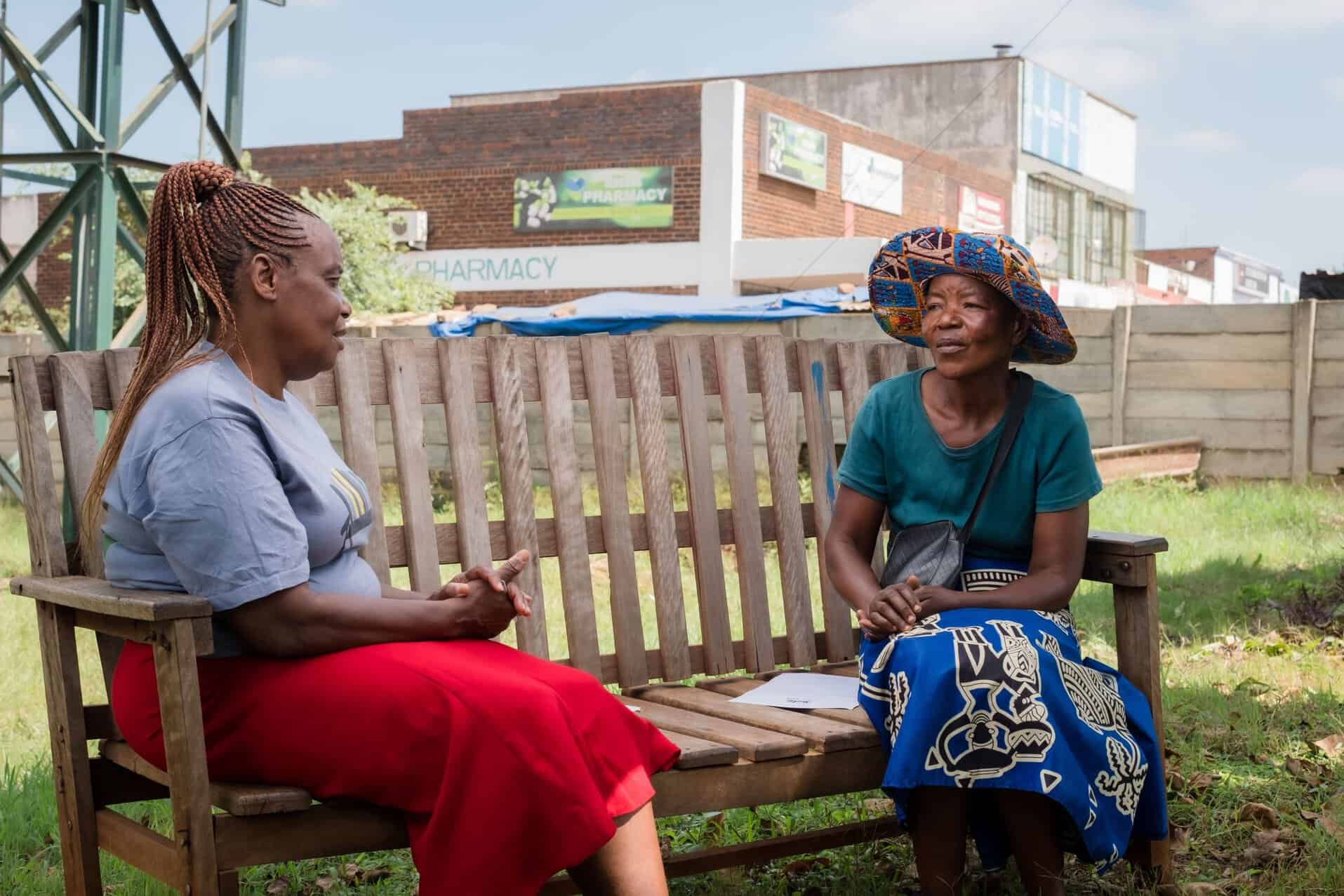 A client during a talk therapy session with a peer counsellor on a Friendship
Bench.