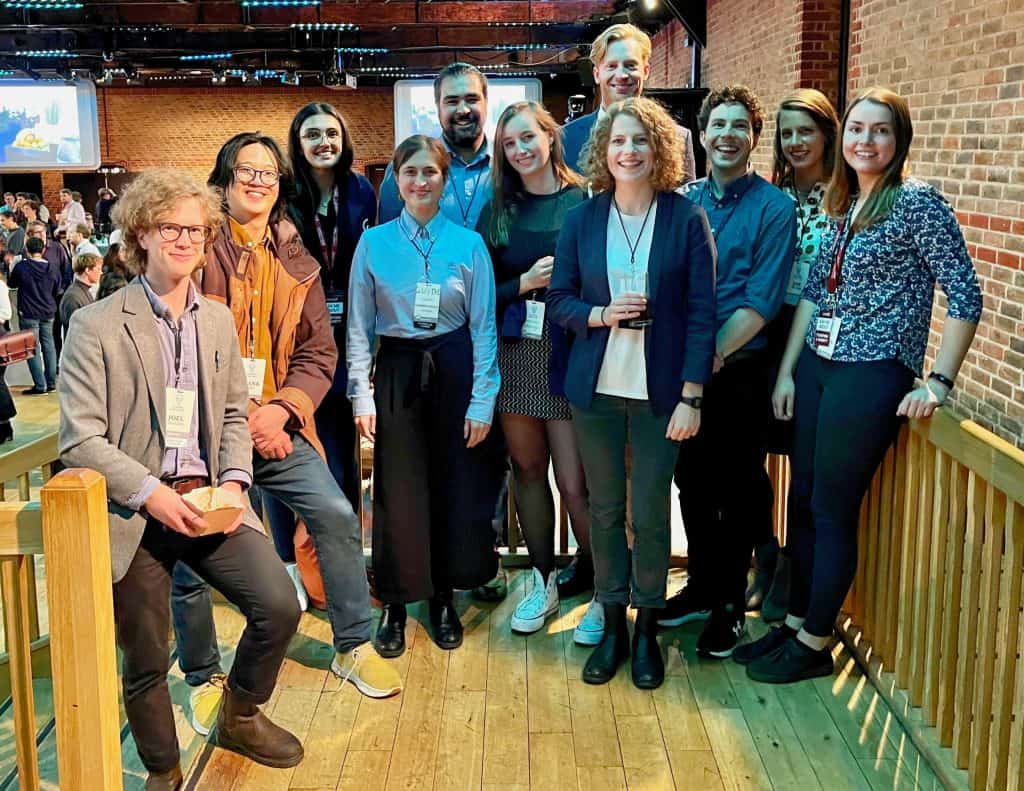 Team members from the Happier Lives Institute portrayed together as they attend a conference