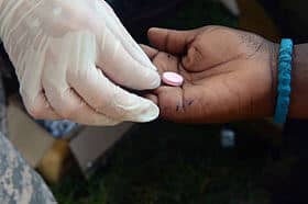 A healthcare worker administering a vaccine to a person's arm.