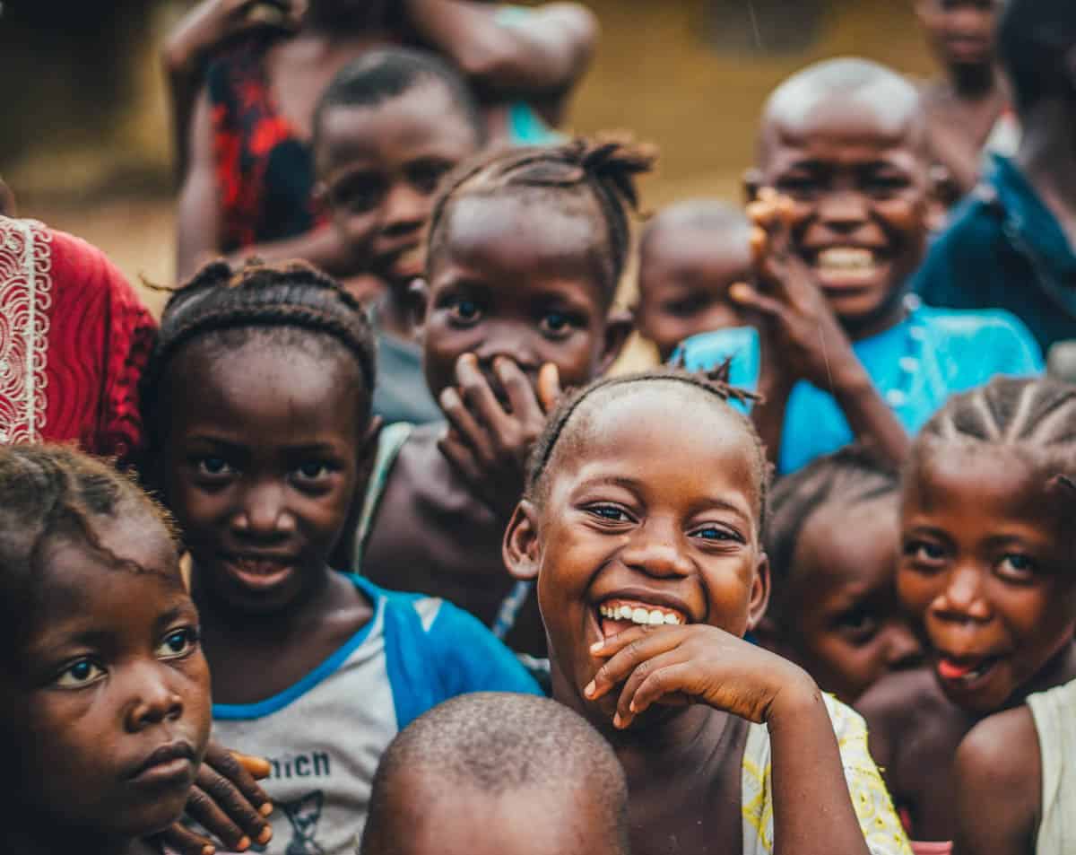 A joyful group of children from a lively community, showcasing happiness and unity.