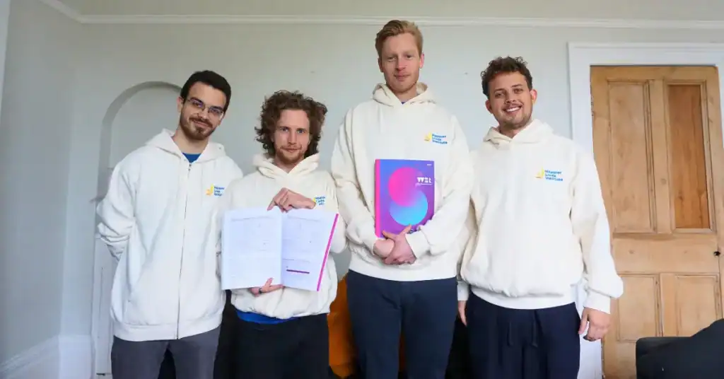 Researchers from the Happier Lives Institute with a physical copy of the 2025 World Happiness Report