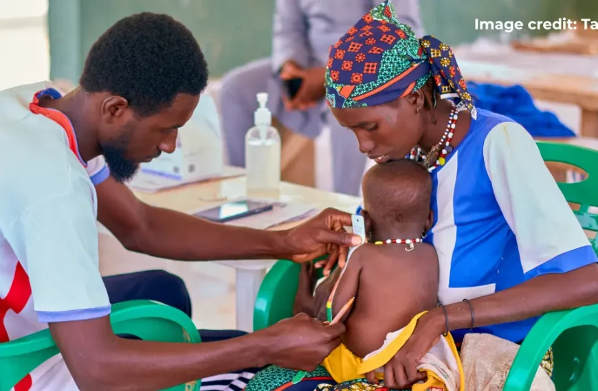 Healthcare worker administering treatment to a child in Nigeria.